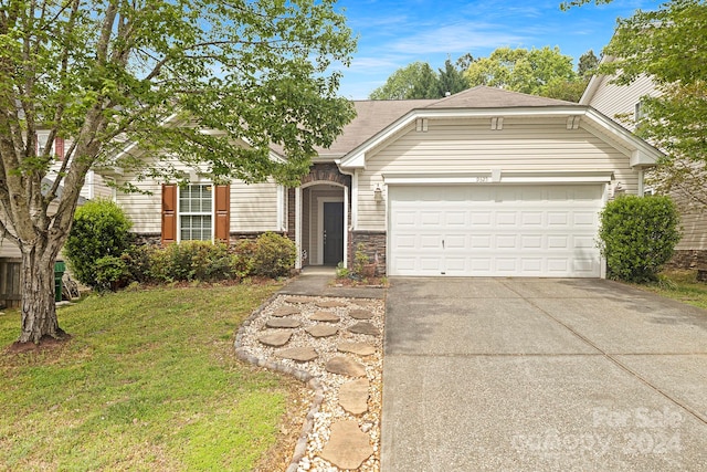 ranch-style home featuring a garage and a front lawn