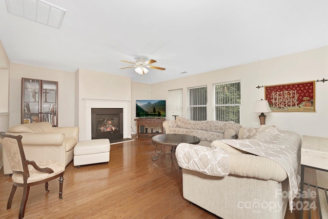 living room featuring light hardwood / wood-style floors and ceiling fan