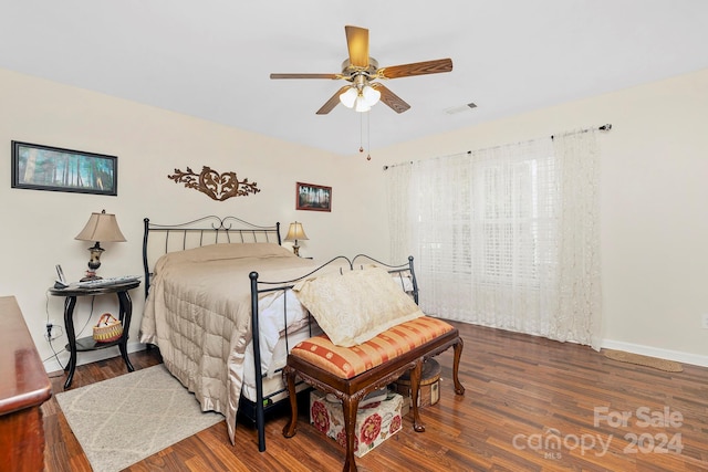 bedroom with dark wood-type flooring and ceiling fan