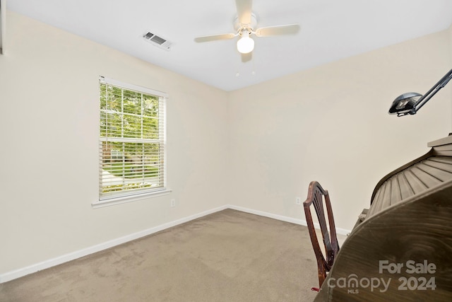 unfurnished office with ceiling fan and carpet flooring