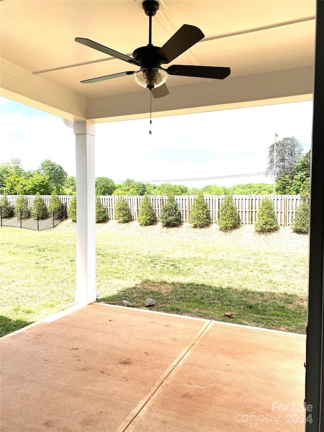 view of yard with ceiling fan and a patio area