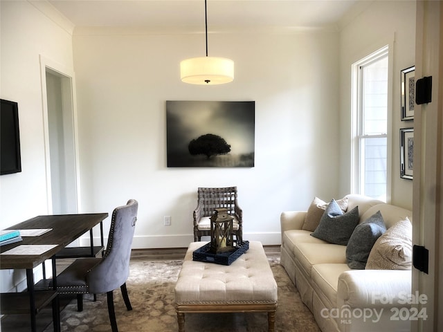 living room with dark wood-type flooring and ornamental molding