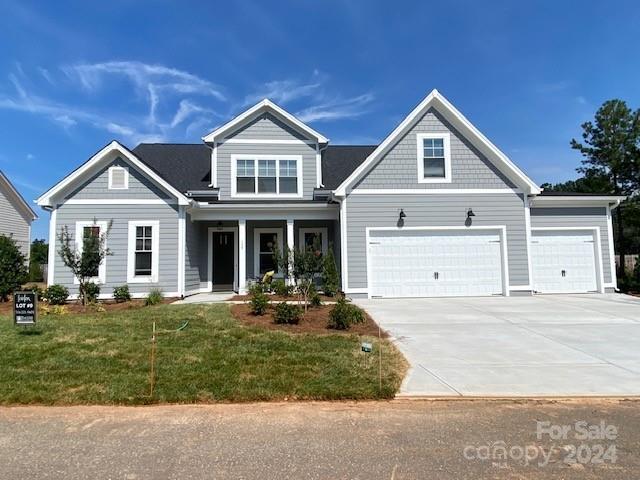 craftsman-style home featuring a garage and a front lawn