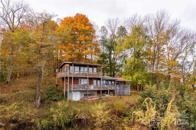 rear view of house featuring a deck