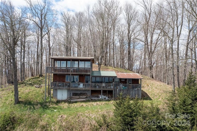 rear view of house featuring a wooden deck