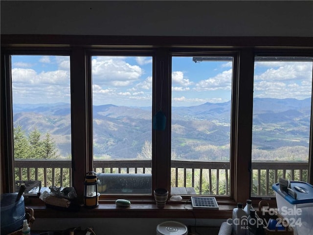 sunroom / solarium featuring a mountain view