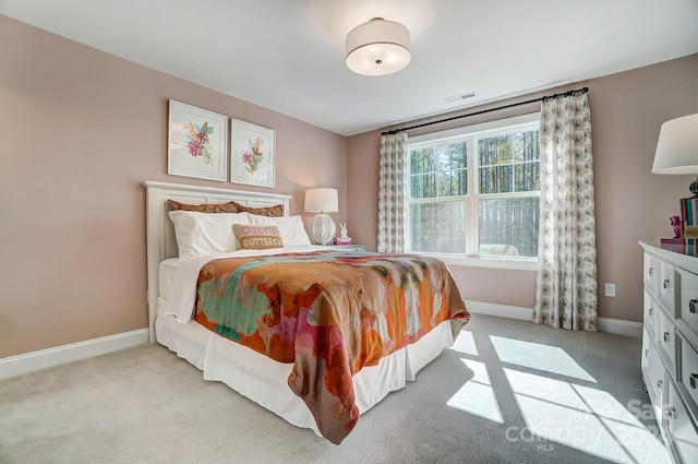 bedroom featuring light carpet