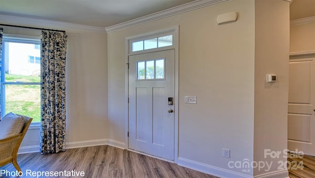 foyer with ornamental molding and light hardwood / wood-style floors