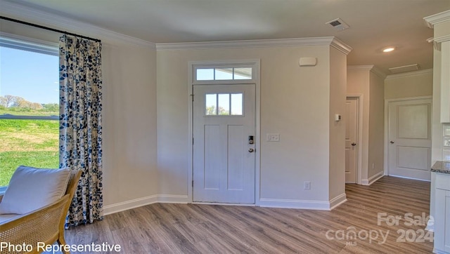 entryway with hardwood / wood-style floors and ornamental molding