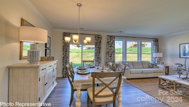 dining area with dark hardwood / wood-style flooring, crown molding, and a notable chandelier