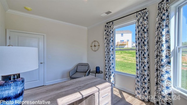 bedroom with ornamental molding and light hardwood / wood-style floors