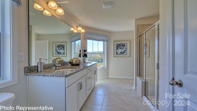 bathroom with large vanity, toilet, and tile flooring