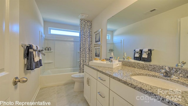 full bathroom featuring large vanity, toilet, tile floors,  shower combination, and dual sinks