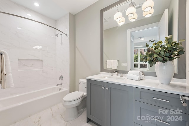 full bathroom featuring tiled shower / bath, toilet, and vanity