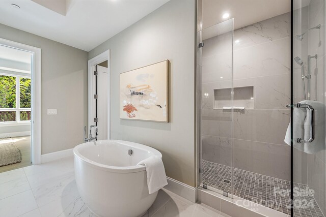 bathroom featuring separate shower and tub