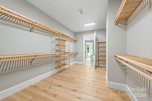 spacious closet featuring hardwood / wood-style floors