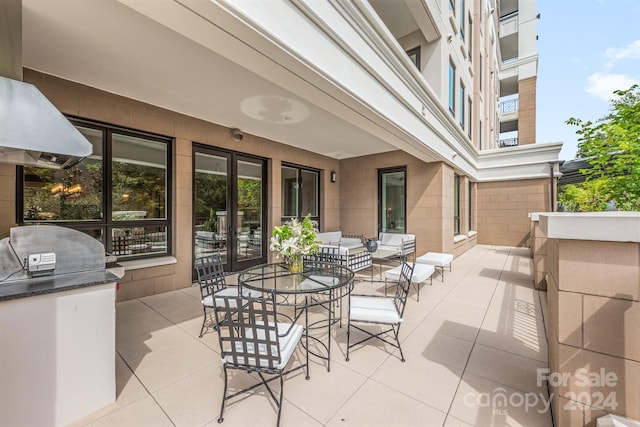 view of patio / terrace with a balcony, area for grilling, and an outdoor kitchen