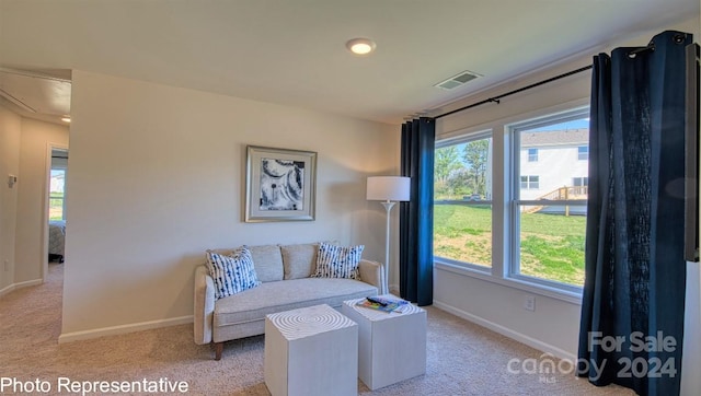 living area featuring light colored carpet