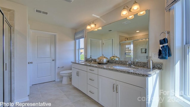 bathroom with walk in shower, large vanity, toilet, tile flooring, and dual sinks