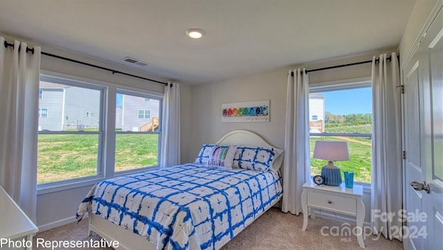 bedroom featuring light colored carpet