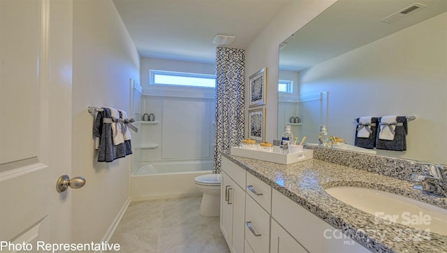 full bathroom featuring tile flooring, dual vanity, a healthy amount of sunlight, and toilet