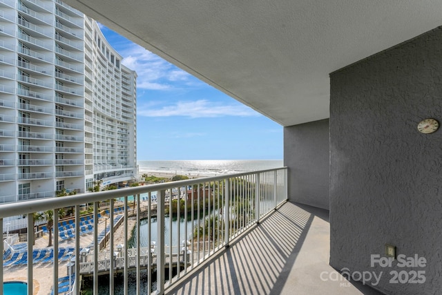 balcony with a view of the beach and a water view