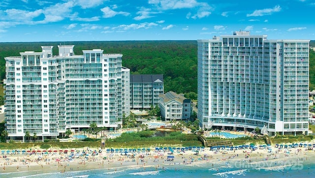 birds eye view of property featuring a view of the beach and a water view