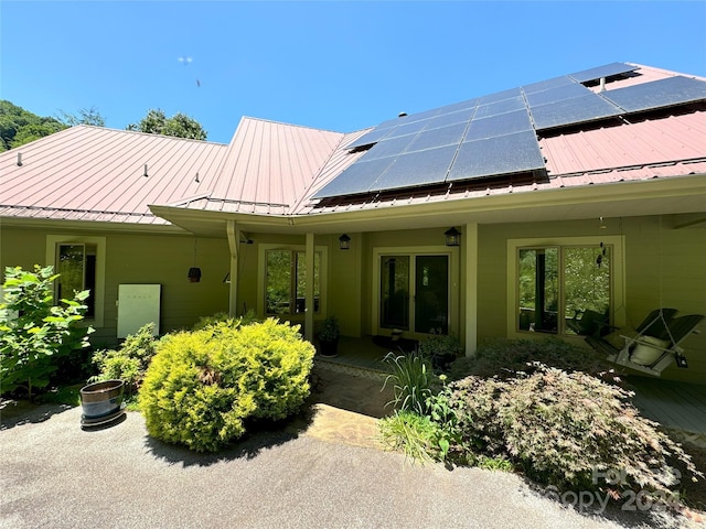 rear view of house with solar panels