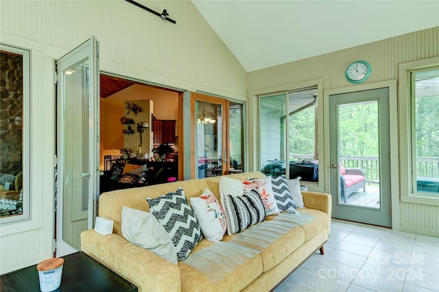 sunroom / solarium featuring lofted ceiling