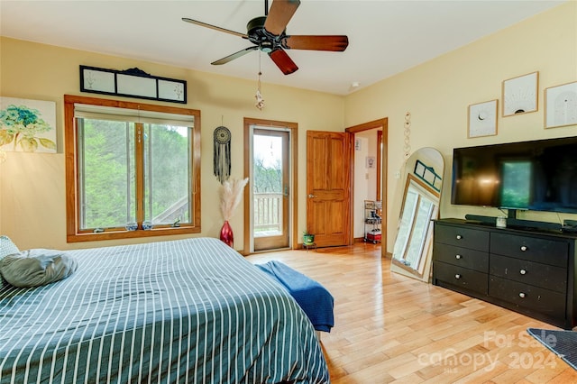 bedroom featuring light wood-type flooring, ceiling fan, and access to exterior