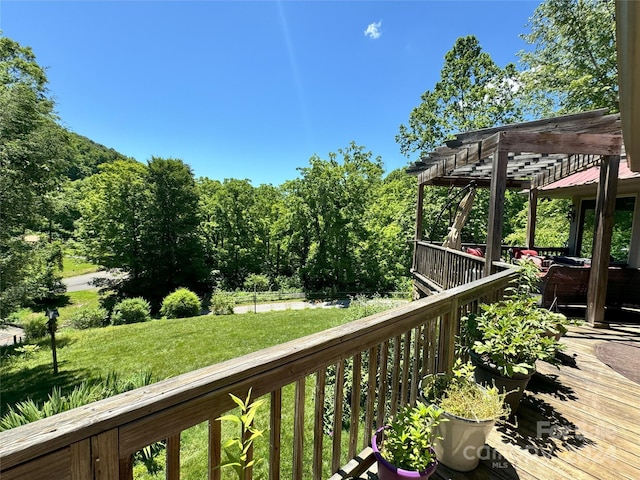 wooden deck with a pergola and a yard