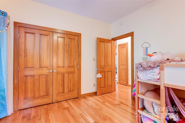 unfurnished bedroom with a closet and light hardwood / wood-style flooring