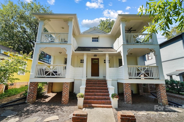 view of front of house with a porch and a balcony