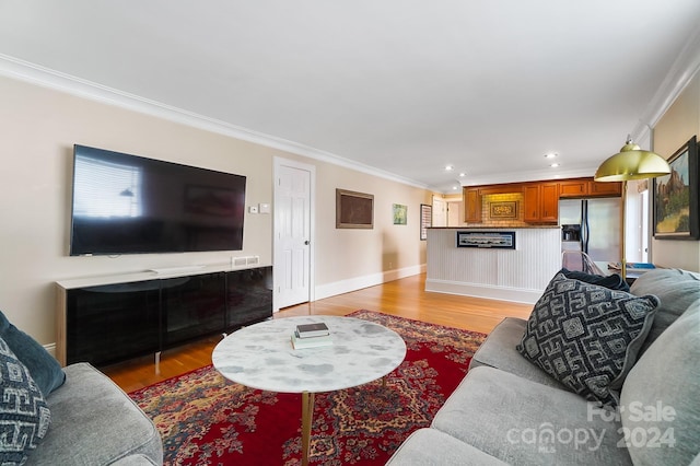 living room with ornamental molding and hardwood / wood-style flooring