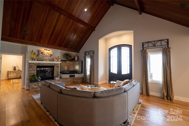 living room with wood ceiling, light wood-type flooring, beamed ceiling, and high vaulted ceiling