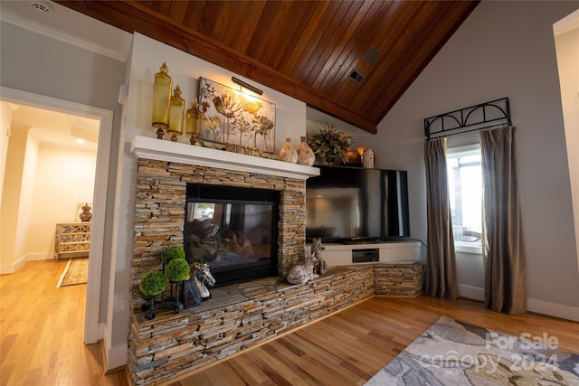 living room featuring wood ceiling, high vaulted ceiling, light hardwood / wood-style flooring, and a stone fireplace