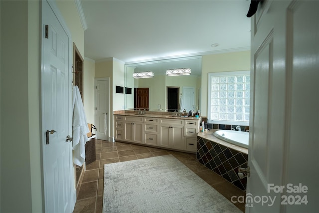 bathroom with a relaxing tiled tub, tile patterned flooring, vanity, and crown molding