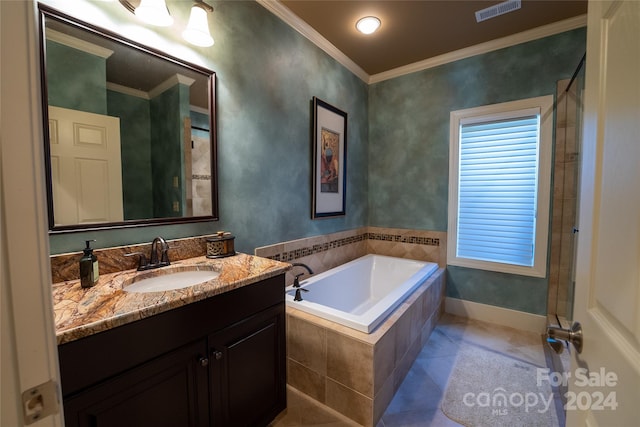 bathroom featuring vanity, ornamental molding, a relaxing tiled tub, and tile patterned flooring