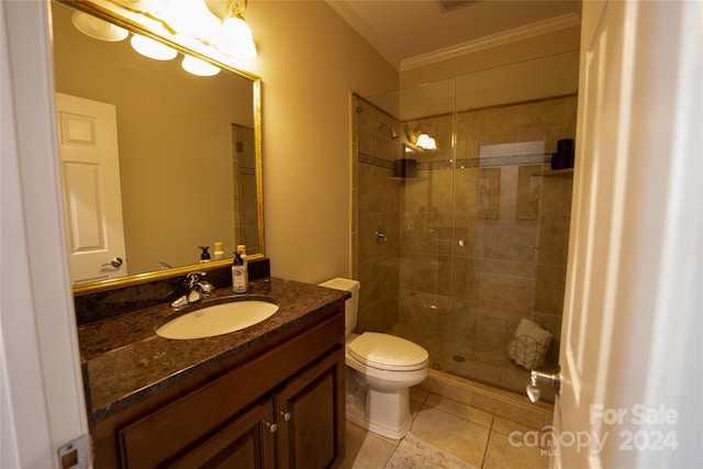 bathroom with vanity, tiled shower, tile patterned floors, crown molding, and toilet