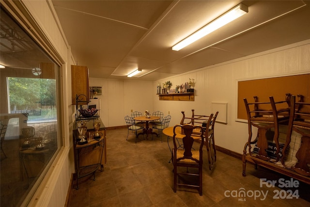 dining area featuring wooden walls