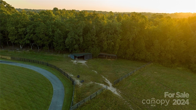 aerial view at dusk featuring a rural view