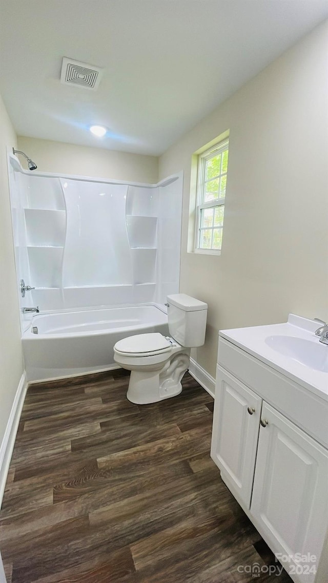 full bathroom with wood-type flooring, vanity, toilet, and bathing tub / shower combination