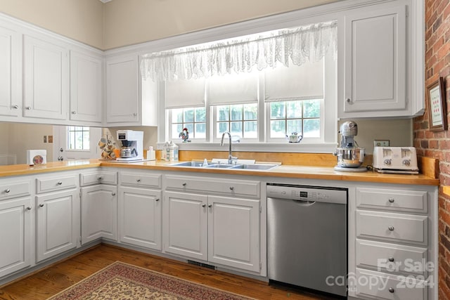 kitchen with dishwasher, sink, white cabinetry, and a healthy amount of sunlight