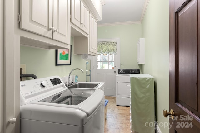 laundry area featuring cabinets, ornamental molding, washing machine and clothes dryer, sink, and light tile floors