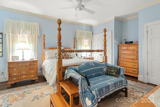 bedroom with dark hardwood / wood-style flooring, ceiling fan, and crown molding