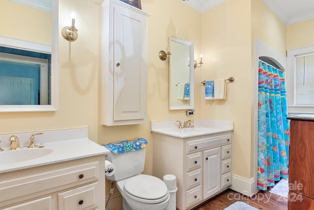 bathroom featuring crown molding, hardwood / wood-style floors, oversized vanity, and toilet