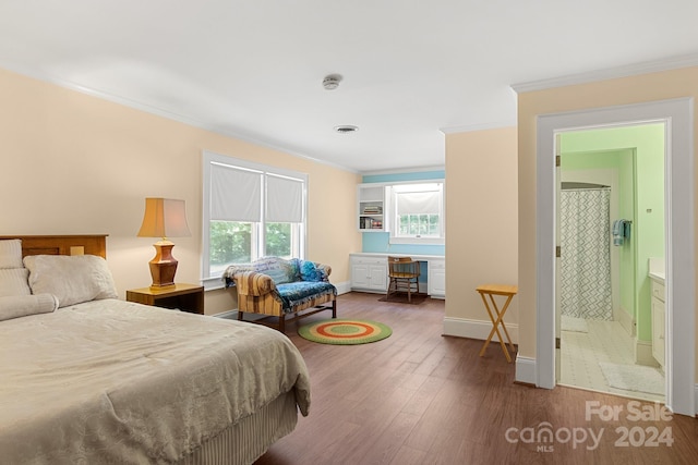 bedroom with crown molding, ensuite bathroom, and wood-type flooring