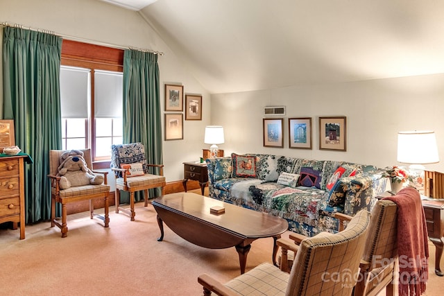 carpeted living room with vaulted ceiling