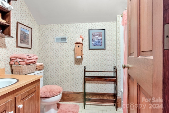 bathroom featuring tile flooring, toilet, and vanity