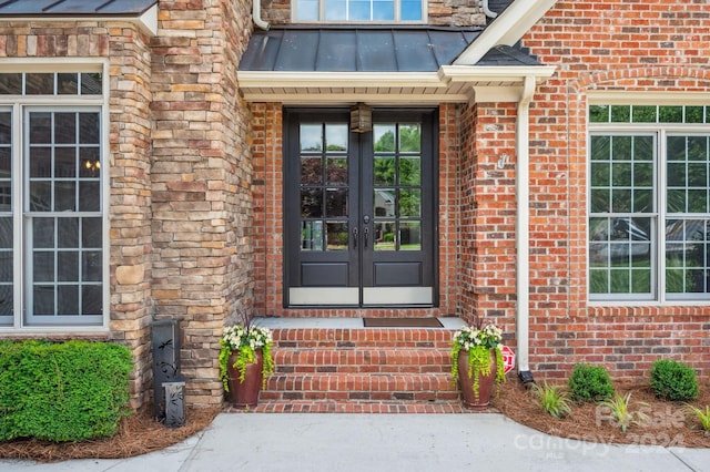 view of exterior entry featuring french doors